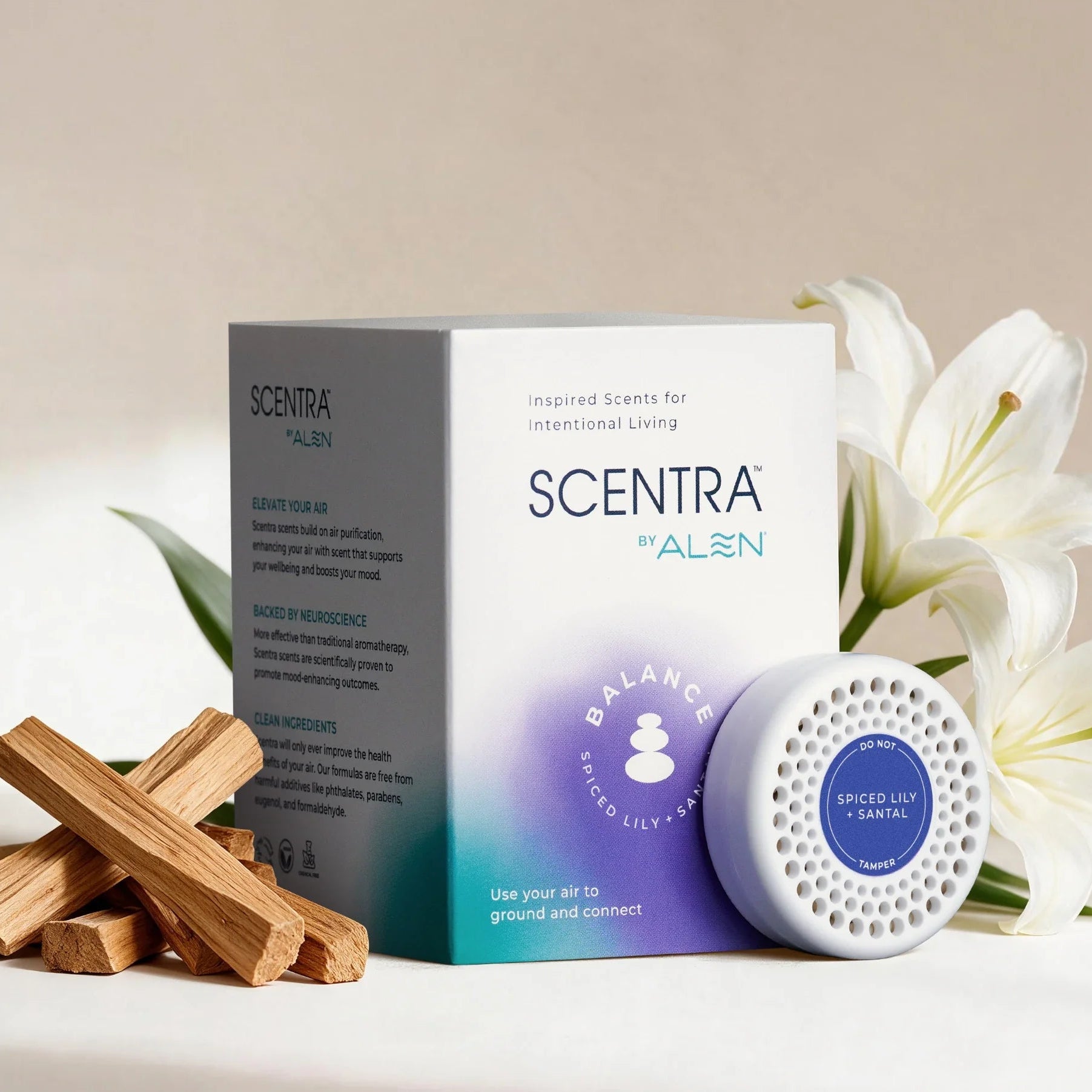 Scentra by Alen scent kit with its box, a white diffuser, and wooden incense sticks, styled with white lilies on a neutral beige background.